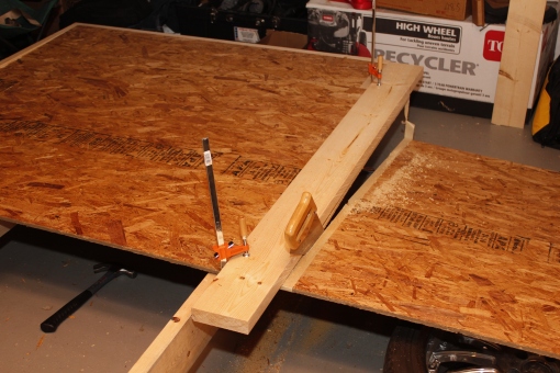 now the mess of cutting the fiber board. dont use this stuff. get actual plywood! i had to get creative on just how to cut it to size using a hand saw.